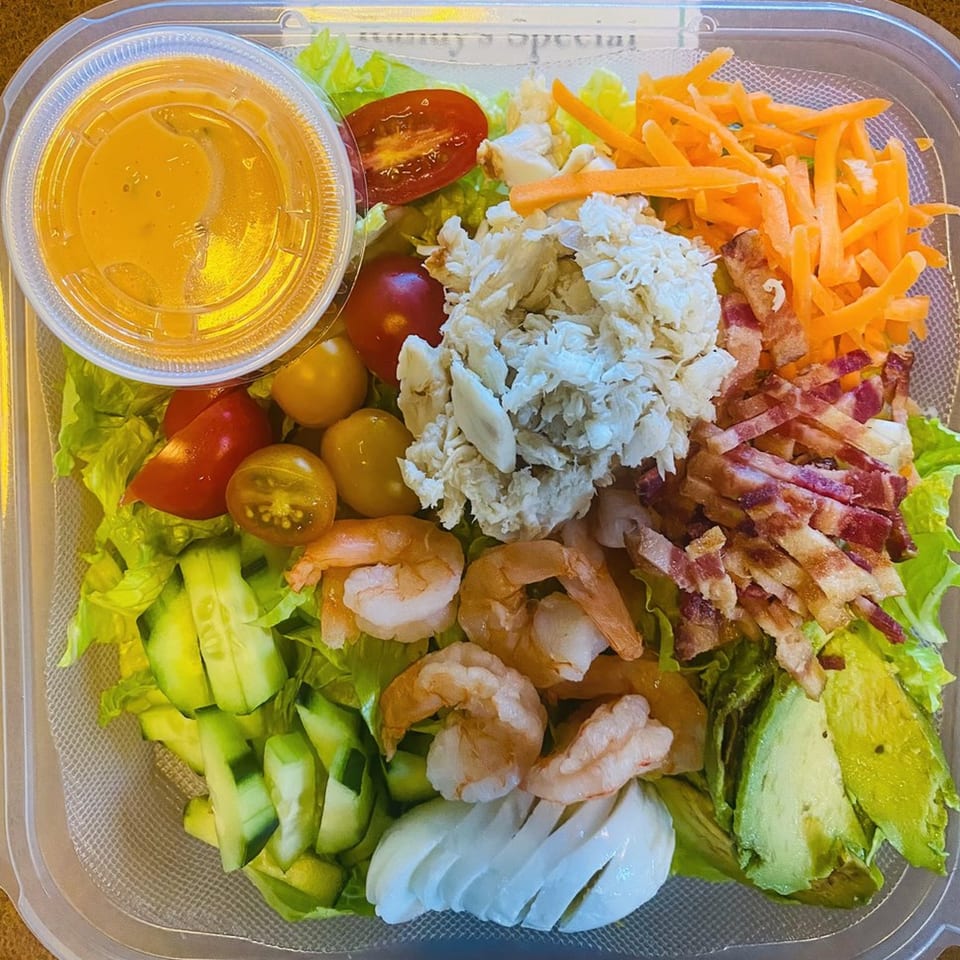 Randy's Bistro's American salad with shrimp, crab, bacon, avocado, tomatoes, and dressing.